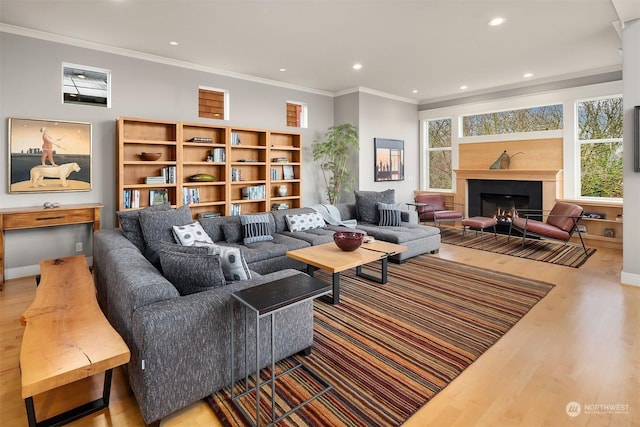 living room with hardwood / wood-style flooring and crown molding