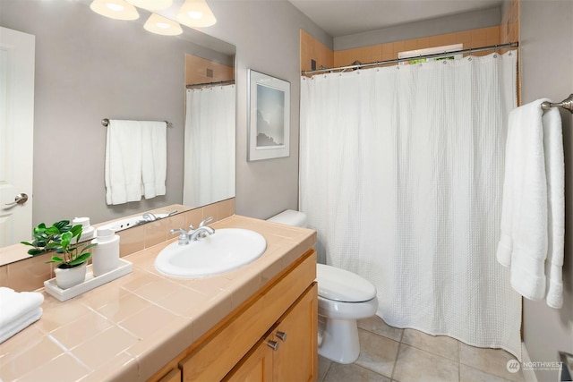 bathroom featuring toilet, vanity, and tile patterned flooring