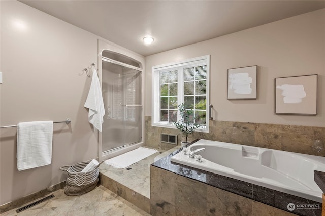 bathroom with separate shower and tub