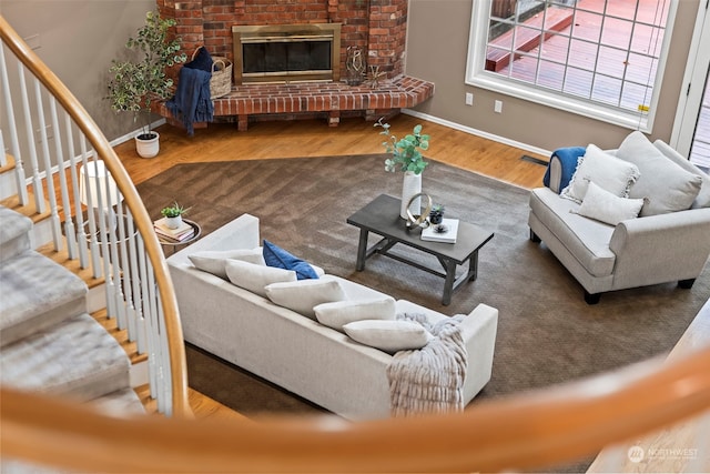 living room with hardwood / wood-style flooring and a fireplace