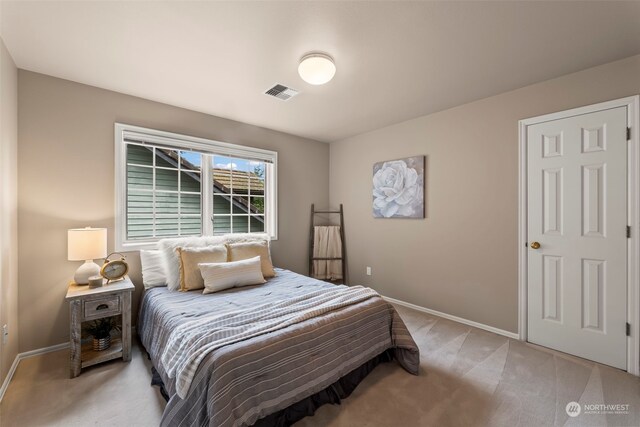 bedroom featuring light carpet