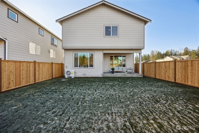 back of property with a patio, a lawn, and ac unit