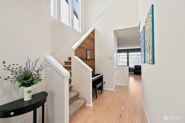 interior space featuring hardwood / wood-style flooring and a high ceiling