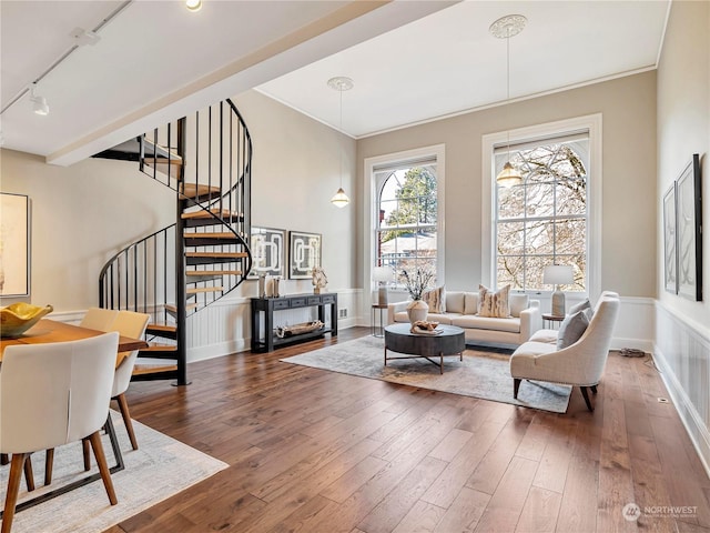 living room with crown molding, track lighting, and dark hardwood / wood-style flooring