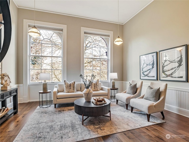 living room with dark wood-type flooring and ornamental molding