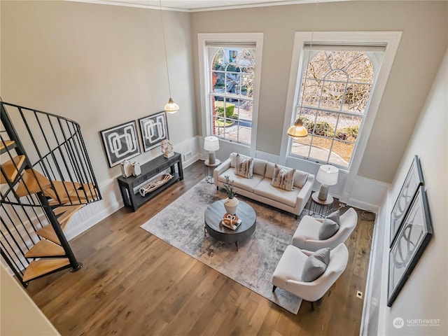 living room featuring hardwood / wood-style flooring, ornamental molding, and plenty of natural light