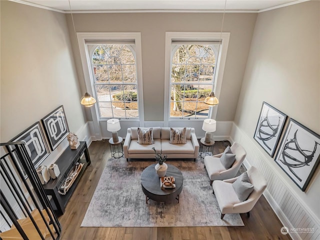 living room with hardwood / wood-style flooring and ornamental molding