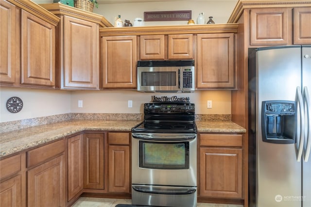 kitchen featuring light stone counters and stainless steel appliances