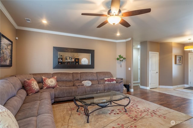 living room with crown molding, light hardwood / wood-style flooring, and ceiling fan