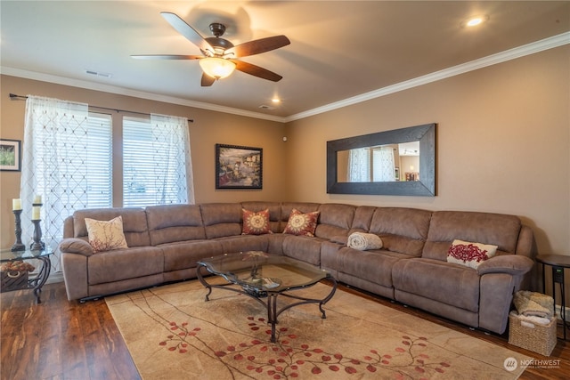 living room with hardwood / wood-style flooring, crown molding, and ceiling fan