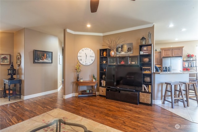 living room featuring crown molding, dark hardwood / wood-style floors, and ceiling fan