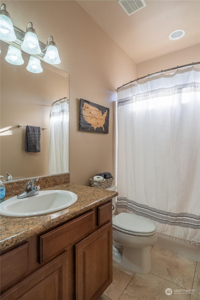 bathroom featuring vanity, tile patterned floors, and toilet