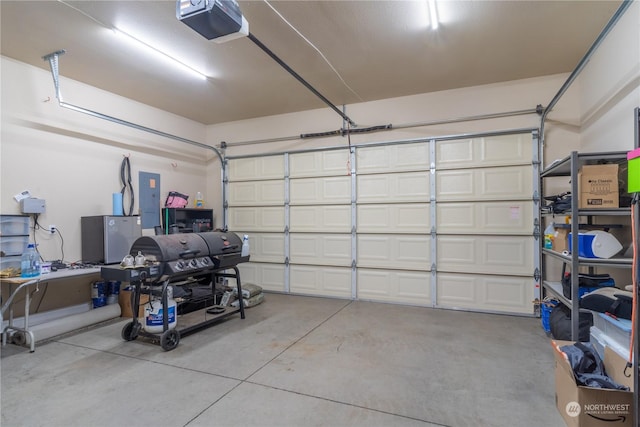 garage featuring a garage door opener and electric panel