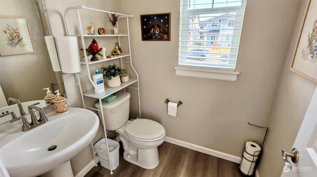 bathroom featuring sink, toilet, and hardwood / wood-style floors