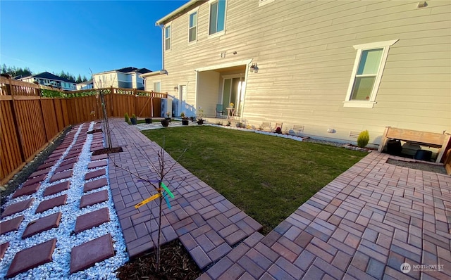 back of house featuring a patio area and a lawn