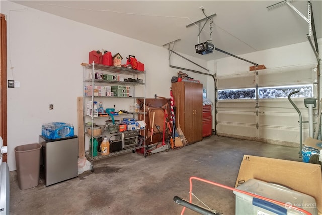 garage featuring stainless steel fridge and a garage door opener