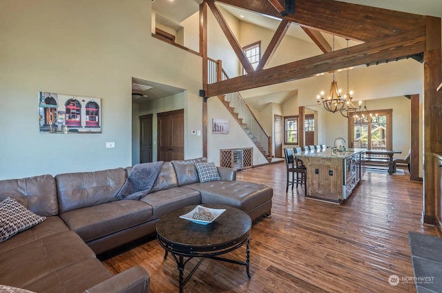 living room with sink, beam ceiling, dark hardwood / wood-style floors, high vaulted ceiling, and a notable chandelier