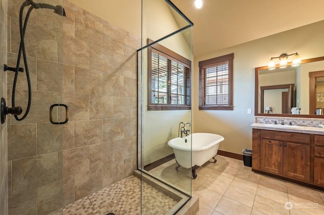 bathroom with tile patterned floors, shower with separate bathtub, vanity, and vaulted ceiling