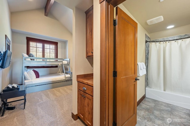 bathroom featuring vanity, shower / tub combo, and lofted ceiling with beams