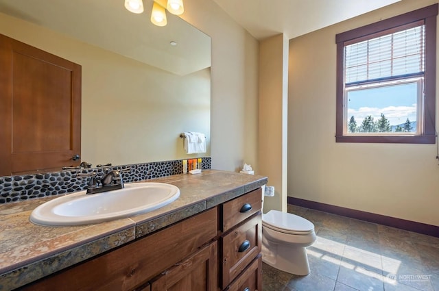 bathroom featuring toilet, tile patterned flooring, and vanity