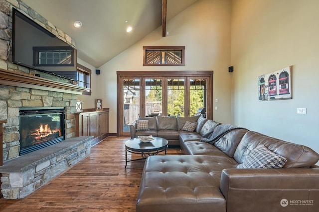 living room with high vaulted ceiling, wood-type flooring, beamed ceiling, and a fireplace