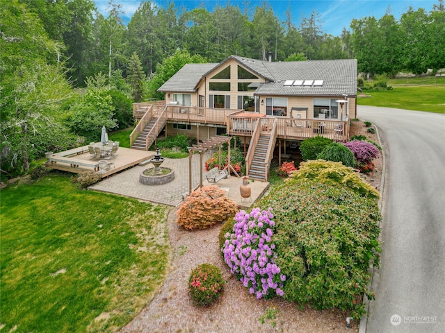 view of front of home with a deck and a front yard