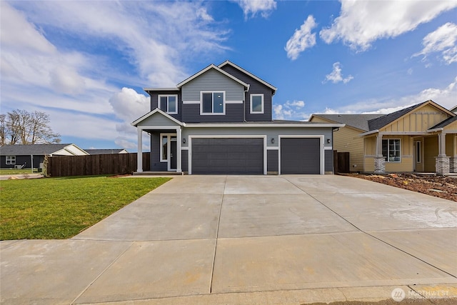 view of front of property with an attached garage, driveway, fence, and a front yard