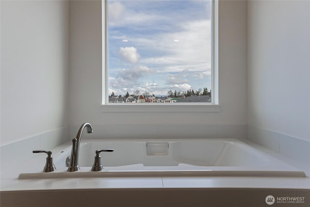 full bathroom with plenty of natural light and a bath