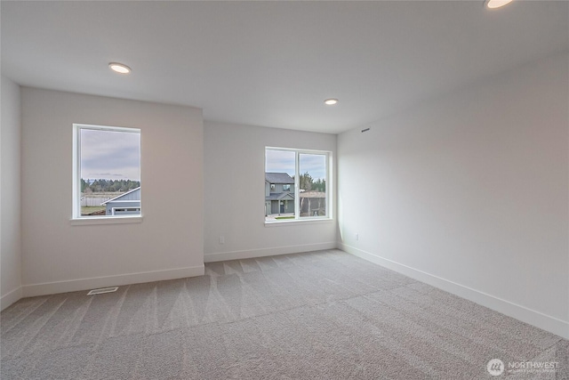 carpeted empty room with recessed lighting and baseboards