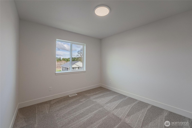 empty room with light carpet, visible vents, and baseboards