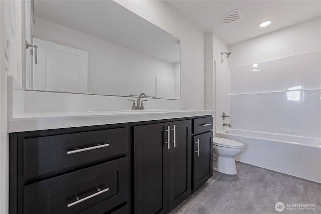 bathroom featuring visible vents, shower / bath combination, vanity, and toilet