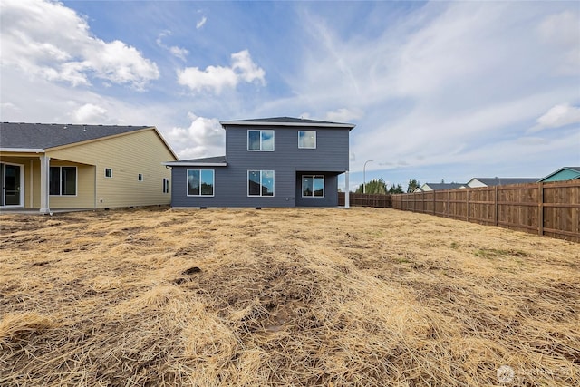 rear view of house with fence