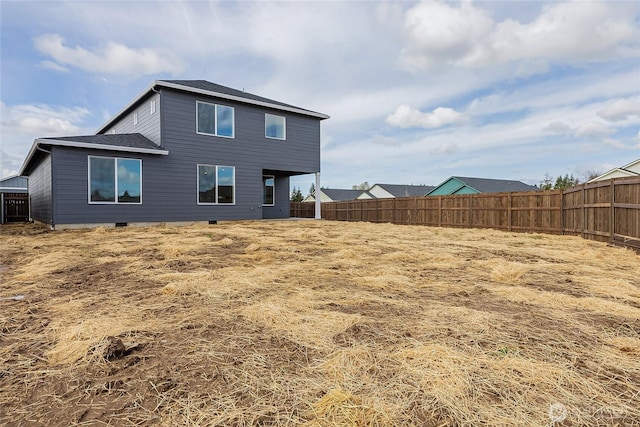 rear view of property featuring crawl space and fence