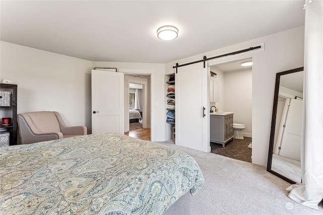 12504 SW 232nd St, Vashon, WA 98070 - carpeted bedroom featuring a barn door and ensuite bathroom