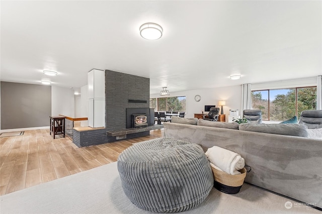 living room featuring a healthy amount of sunlight, light wood-type flooring, and baseboards