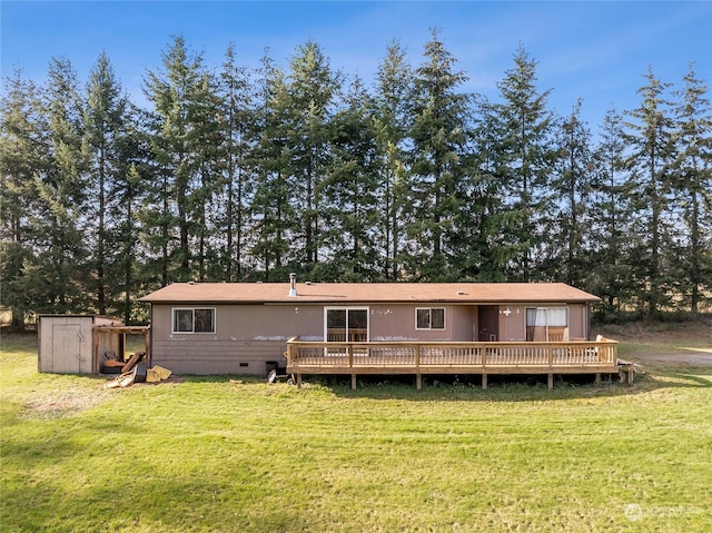 back of house featuring crawl space, a wooden deck, and a yard