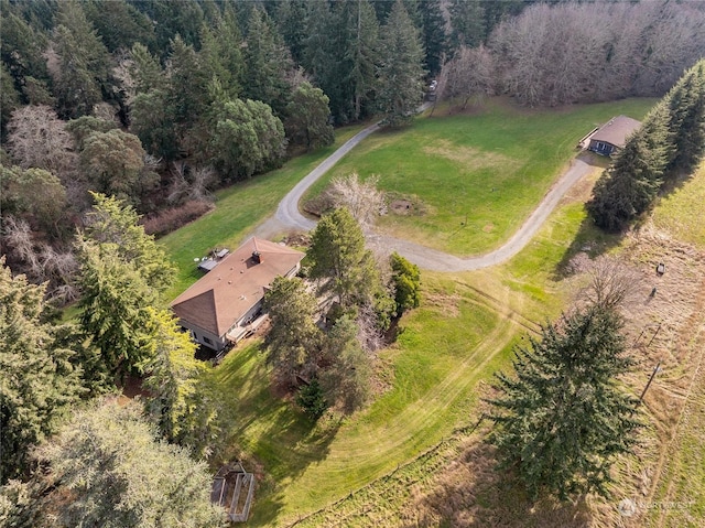 bird's eye view with a wooded view