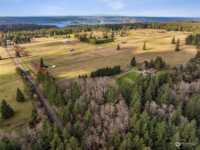 birds eye view of property featuring a rural view and a view of trees