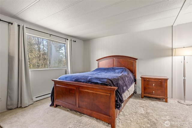 bedroom with carpet and baseboard heating