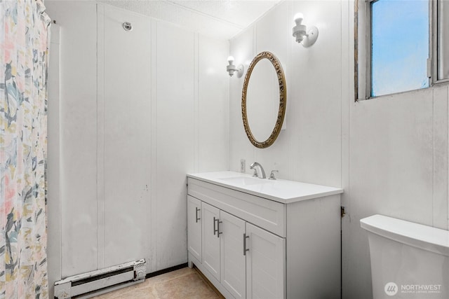 full bathroom with a baseboard heating unit, vanity, and toilet