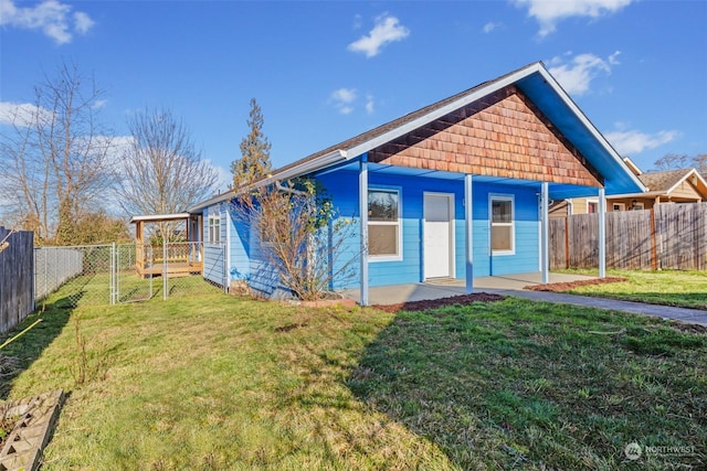 rear view of house with a yard and a patio