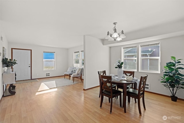 dining room featuring a chandelier and light hardwood / wood-style flooring