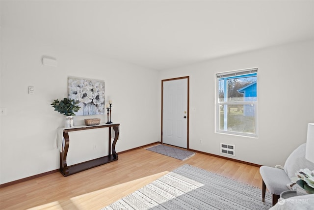 sitting room with heating unit and hardwood / wood-style floors