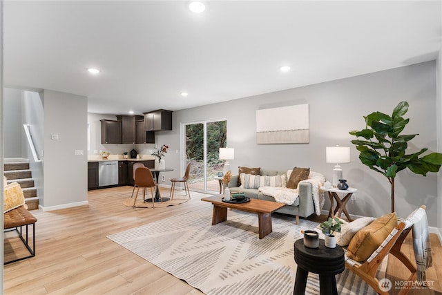 living area featuring stairway, recessed lighting, light wood-type flooring, and baseboards