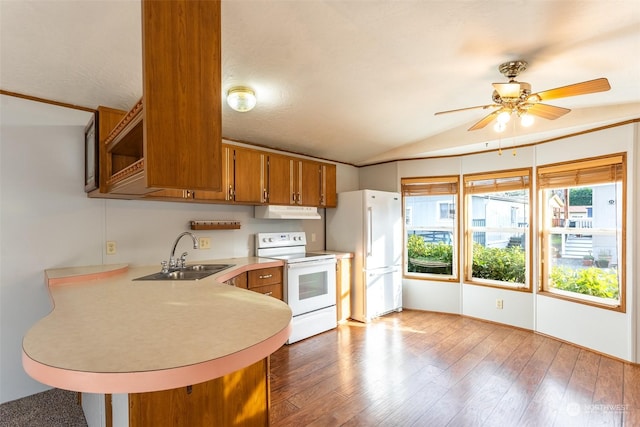 kitchen with white appliances, lofted ceiling, sink, kitchen peninsula, and light hardwood / wood-style flooring