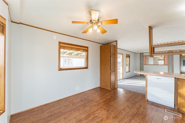 kitchen featuring crown molding, wood-type flooring, and white dishwasher