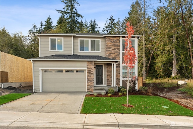 view of front of home with a front yard and a garage