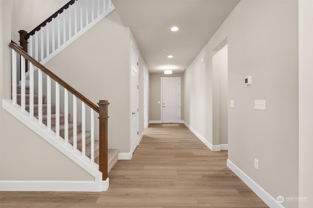 corridor with light hardwood / wood-style floors