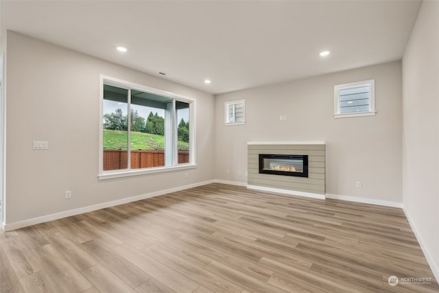 unfurnished living room with visible vents, recessed lighting, light wood-type flooring, and baseboards