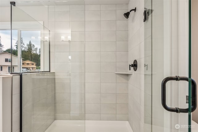 bathroom with a shower with door